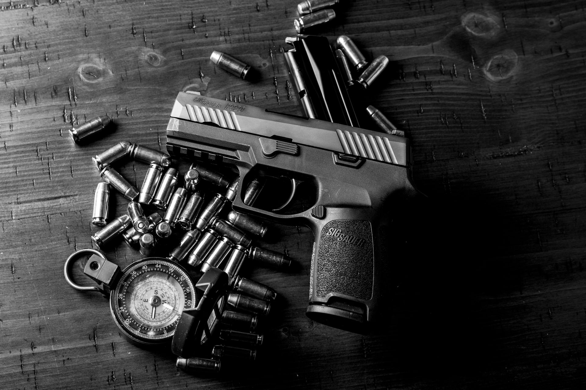 Handgun and Bullets on Wooden Table