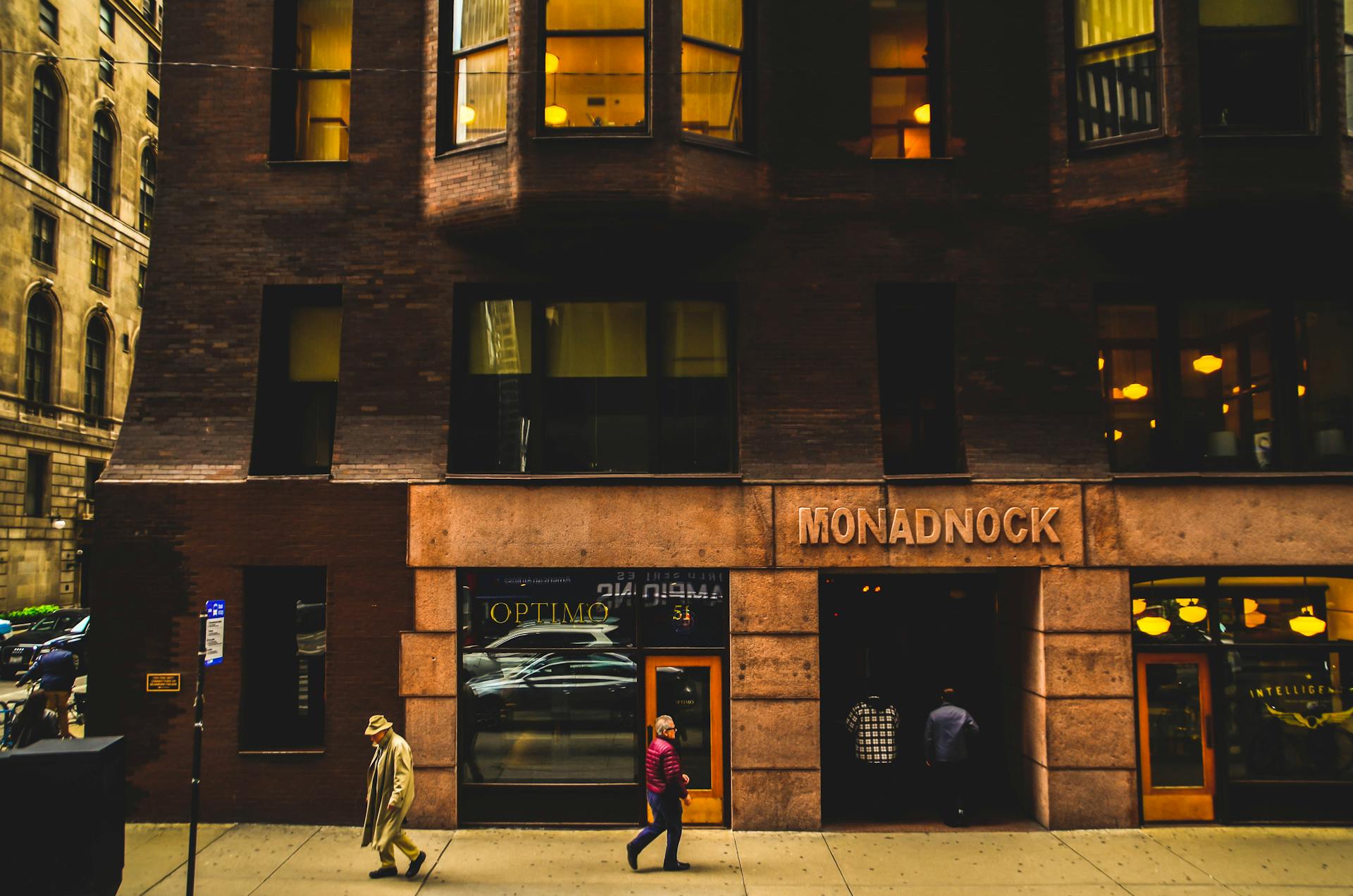 Street view of the historic Monadnock Building in downtown Chicago with passersby.