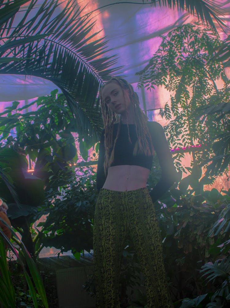 A Woman Black Crop Top Inside A Greenhouse