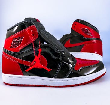 Close-up of red and black Air Jordan sneakers showcasing iconic design and brand logo.