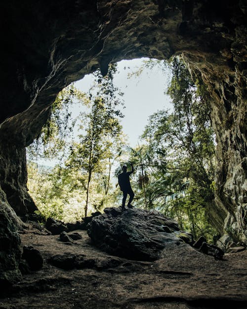 Man Standing Inside a Cave