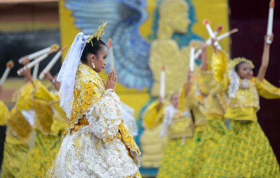 Colorful Sinulog festival dancers in traditional attire performing in Cebu City, Philippines.