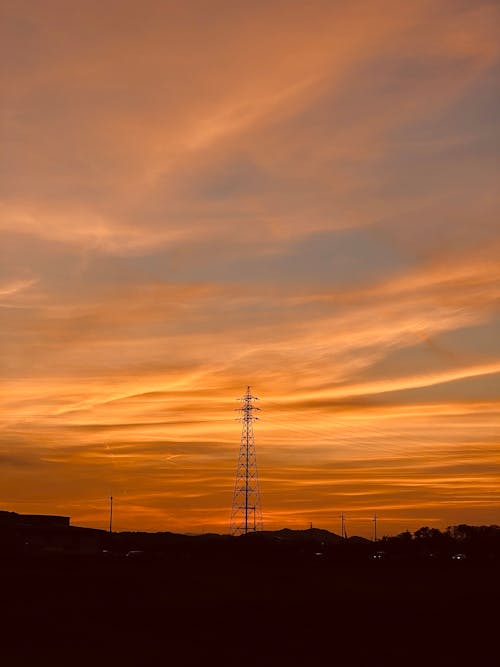 Silhouetted Transmission Tower at Sunset 