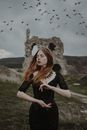 Woman in Black Dress with Birds Flying in the Sky