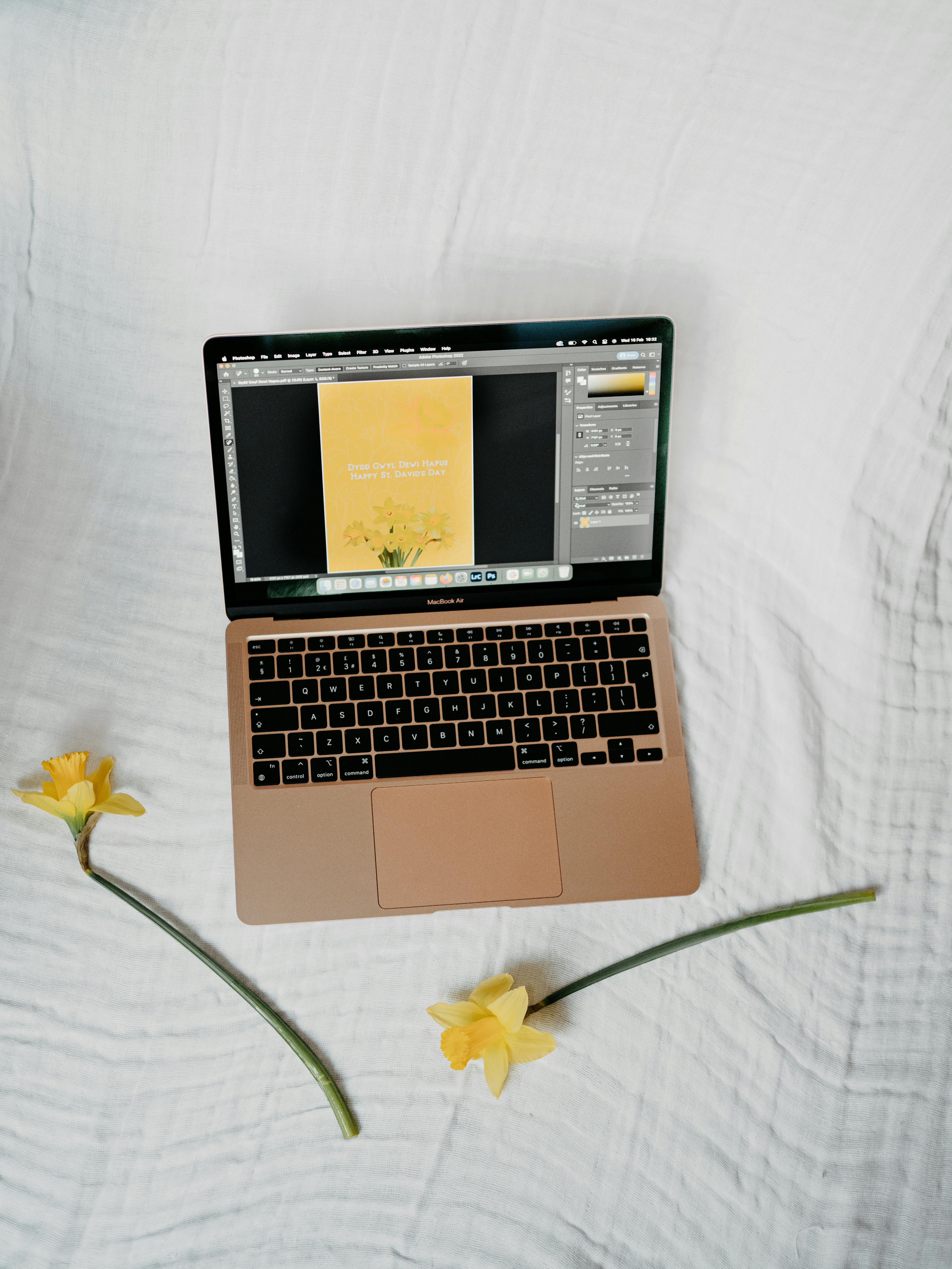 laptop and daffodil flowers
