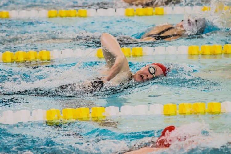 A Woman Swimming In A Pool 