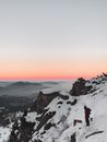 A Man Standing on the Snow Covered Mountain
