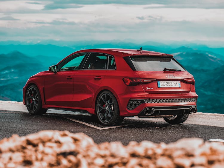 Red Audi RS3 Sedan Parked On The Road With Mountain View