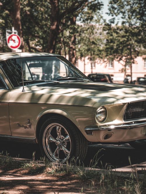 Free Close-up view of a vintage Ford Mustang parked outdoors, featuring classic design elements. Stock Photo