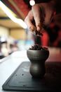 Leveling Tobacco in Clay Bowl with Fingers