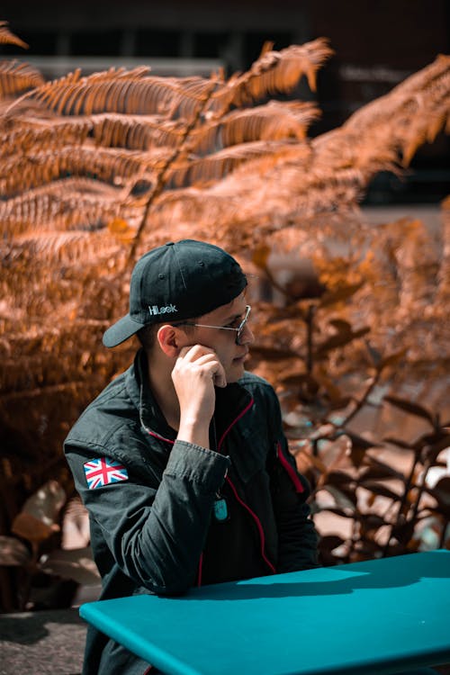 Man Wearing a Hat and Sunglasses