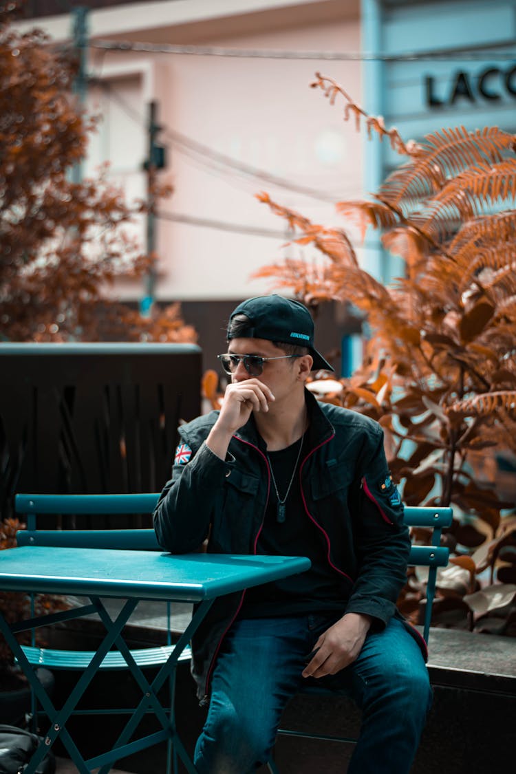 A Man Sitting At The Table While Waiting 