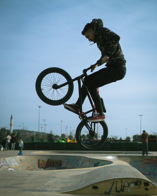 Free A teenager executes a stunt on a BMX bike in an outdoor skatepark in Istanbul, Turkey. Stock Photo