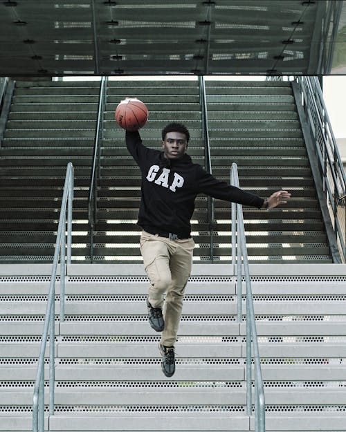 Free Man with Basketball on Stairs Stock Photo