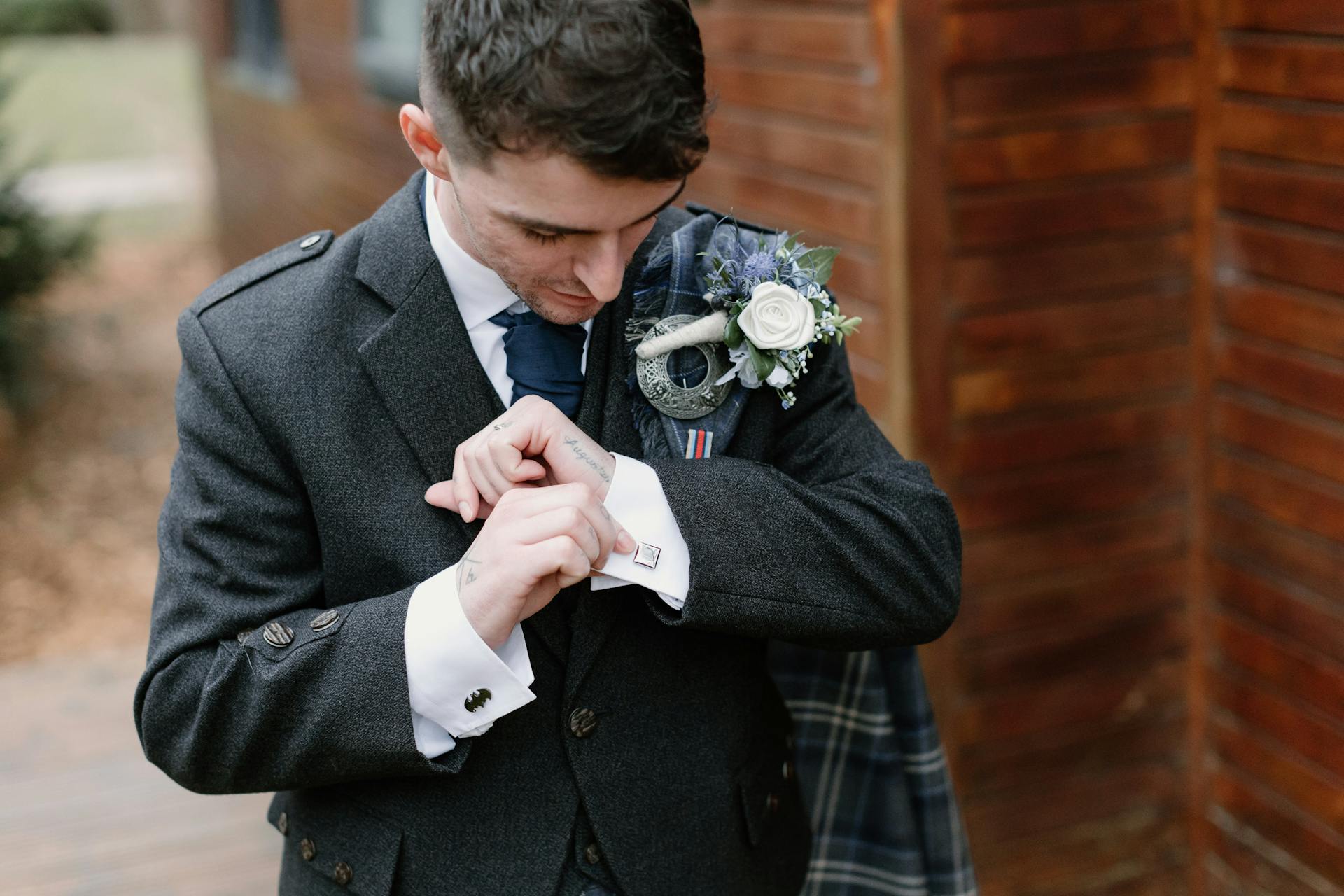 Groom Fixing Cuffs of His White Shirt