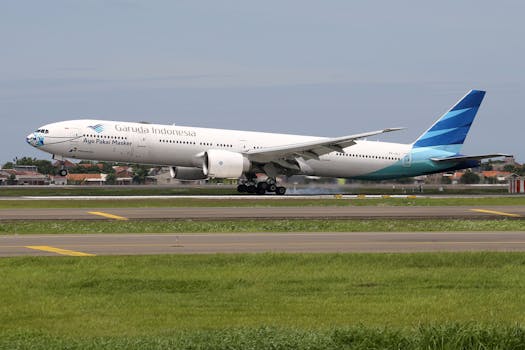 Garuda Indonesia aircraft taking off from an airport runway, emphasizing speed and travel.