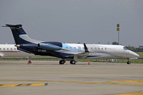 Free A sleek private jet parked on a sunny airport tarmac, ready for departure. Stock Photo