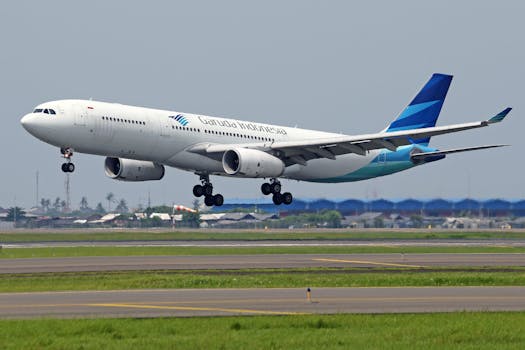 Garuda Indonesia Airbus A330 airliner in mid-takeoff at airport.