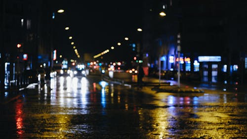 Wet City Street With Lights during Night Time