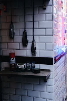 Hanging razors and shaving products on a shelf in a modern barbershop setting.