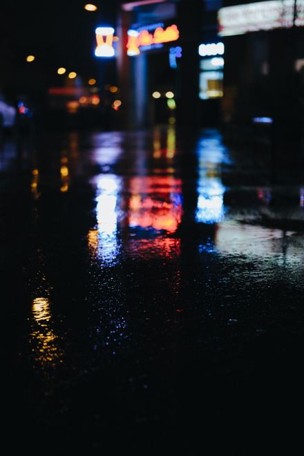 Rain-slicked street at night, photo by Mathias Reding on Pexels