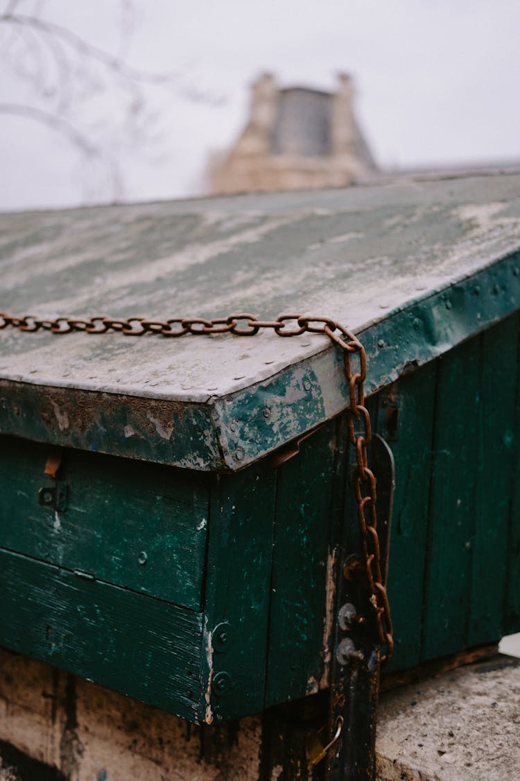 Rusty Metal Chain On Green Wooden Box With Padlock