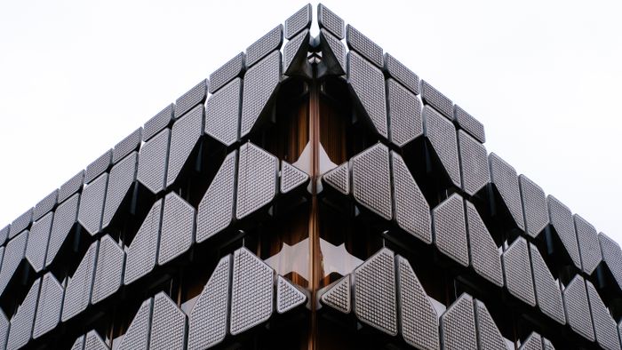 Geometric dark facade of a city commercial building