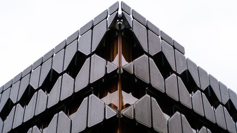 Geometric dark facade of a city commercial building