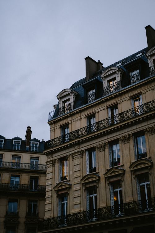 Free Low angle view of a classic Parisian building with ornate facade and historical architecture. Stock Photo
