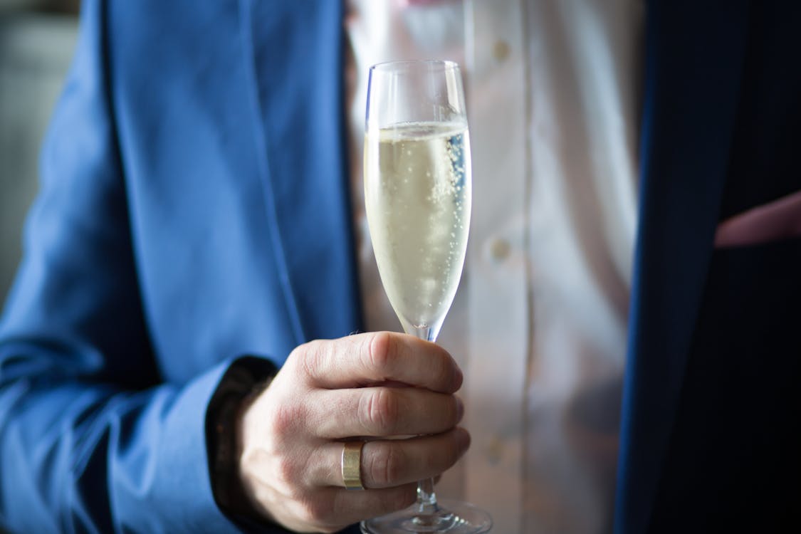 Free Man Holding Filled Champagne Stock Photo