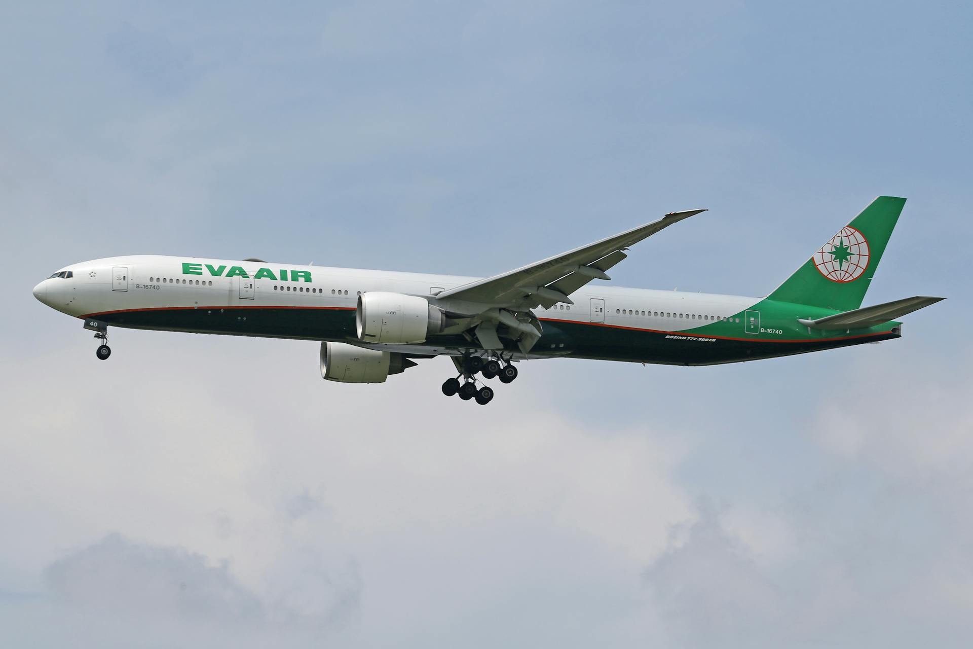 Side view of an EVA Air Boeing 777 flying against a clear blue sky.