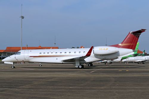 Free A sleek private jet parked on an airport runway under a clear sky. Stock Photo