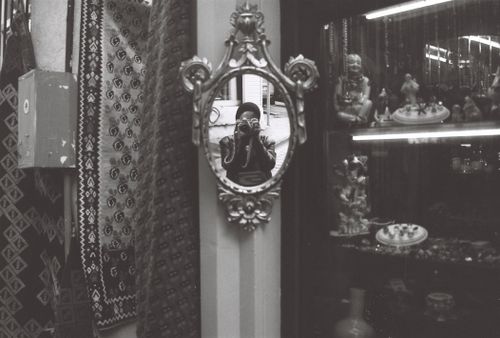 Free Artistic black and white reflection of a photographer capturing their image in a vintage mirror in an antique store. Stock Photo