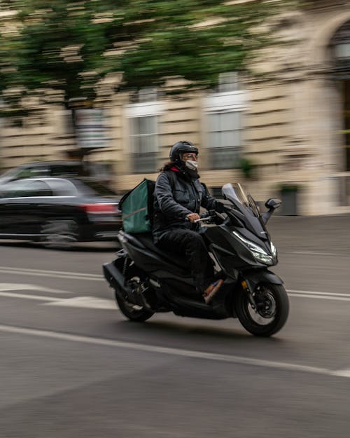 Man Riding his Motorcycle on the Street