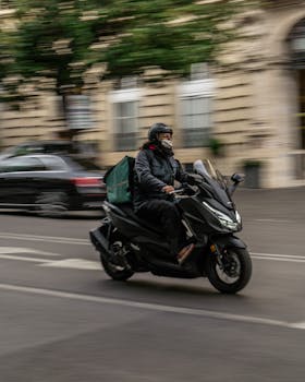 A motorcyclist rides swiftly through a busy street in Rome, capturing urban life in motion.