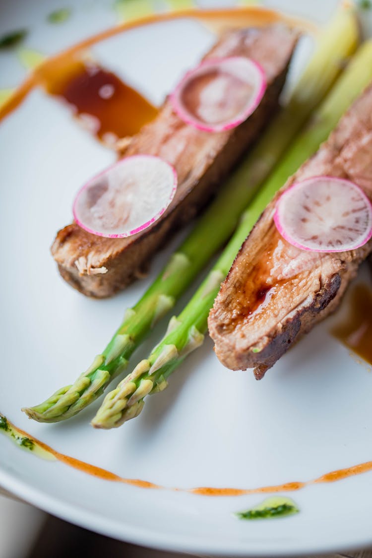 Rare Tenderloin With Green Asparagus Decorated With Spicy Sauce