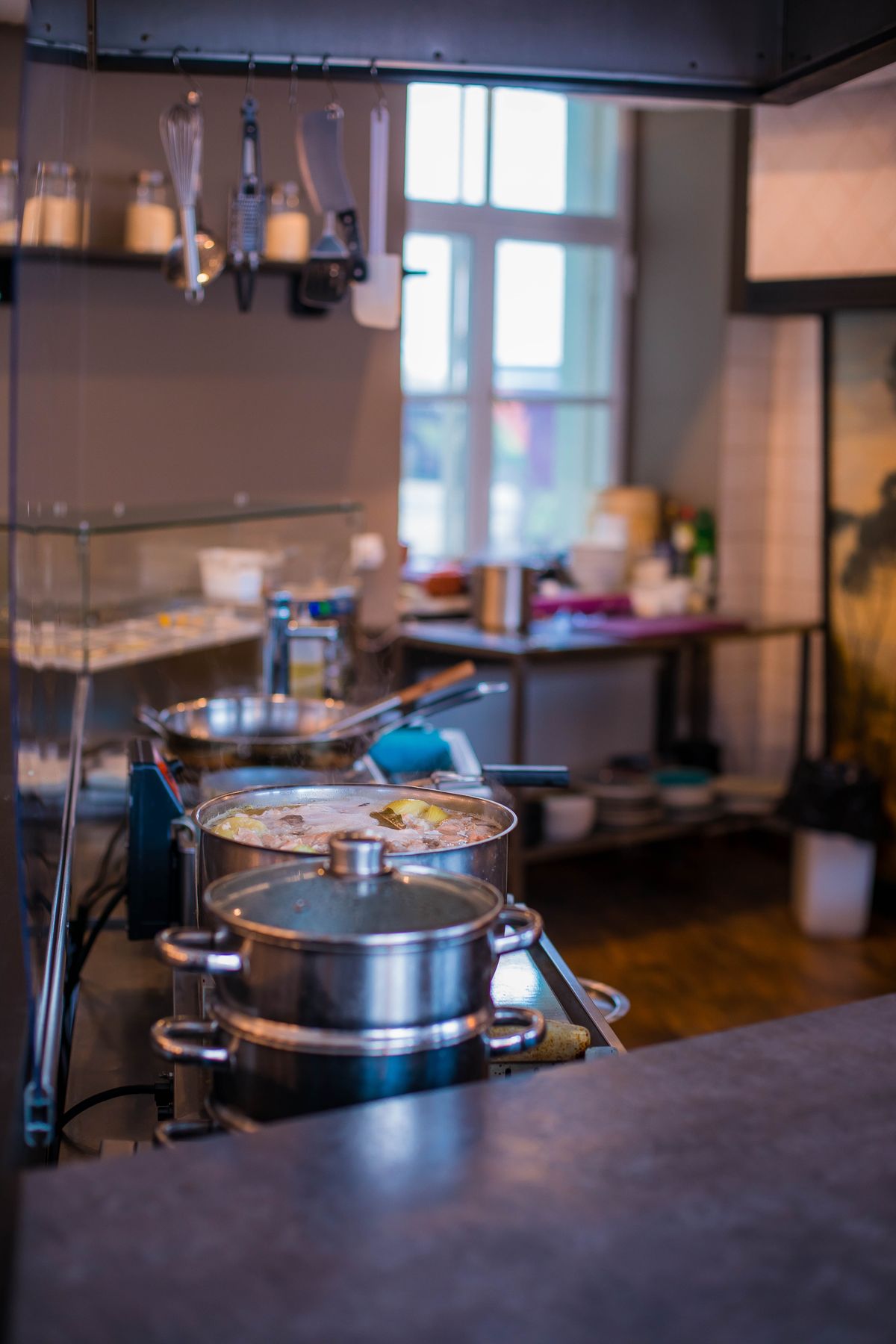Stainless steel cookware in a warm modern kitchen