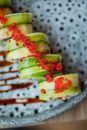 Slices of Cucumber Garnished with Red Caviar Presented on Plate