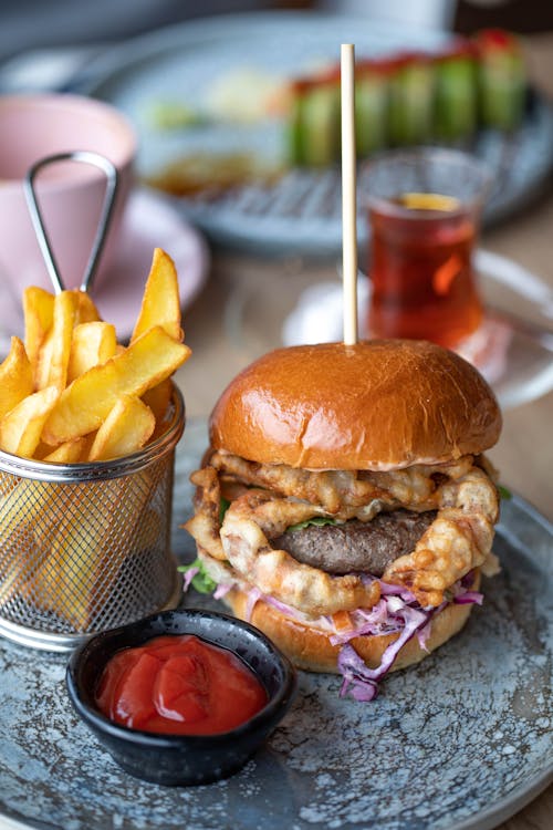 Free Big Hamburger Served with Chips and Ketchup Stock Photo