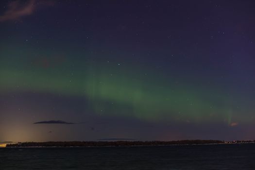 A breathtaking view of the aurora borealis illuminating a starry night sky.