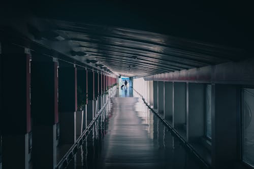A Person Walking at the Corridor