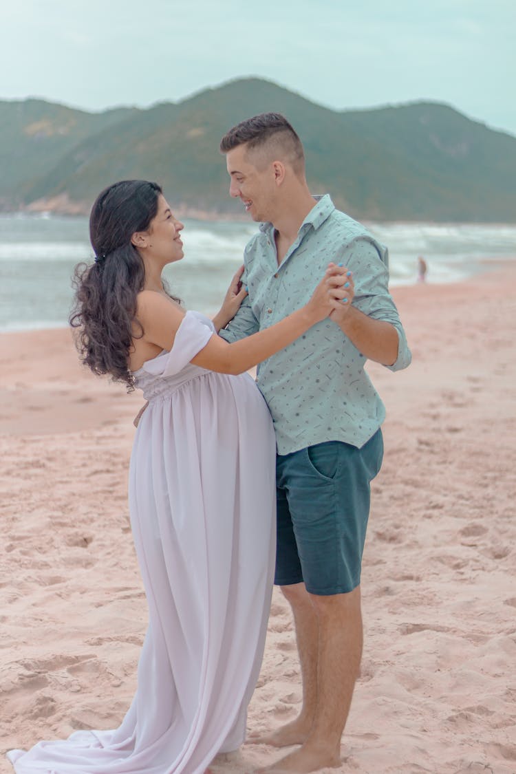 A Husband And Wife Dancing On The Beach