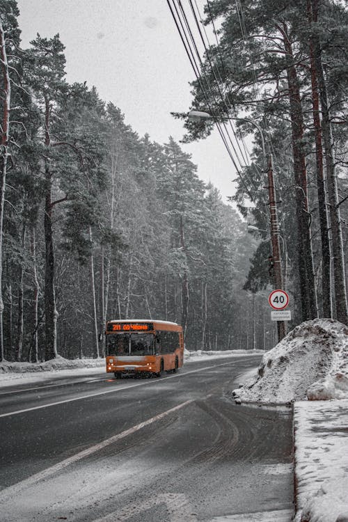Yellow Bus on Road Covered With Snow