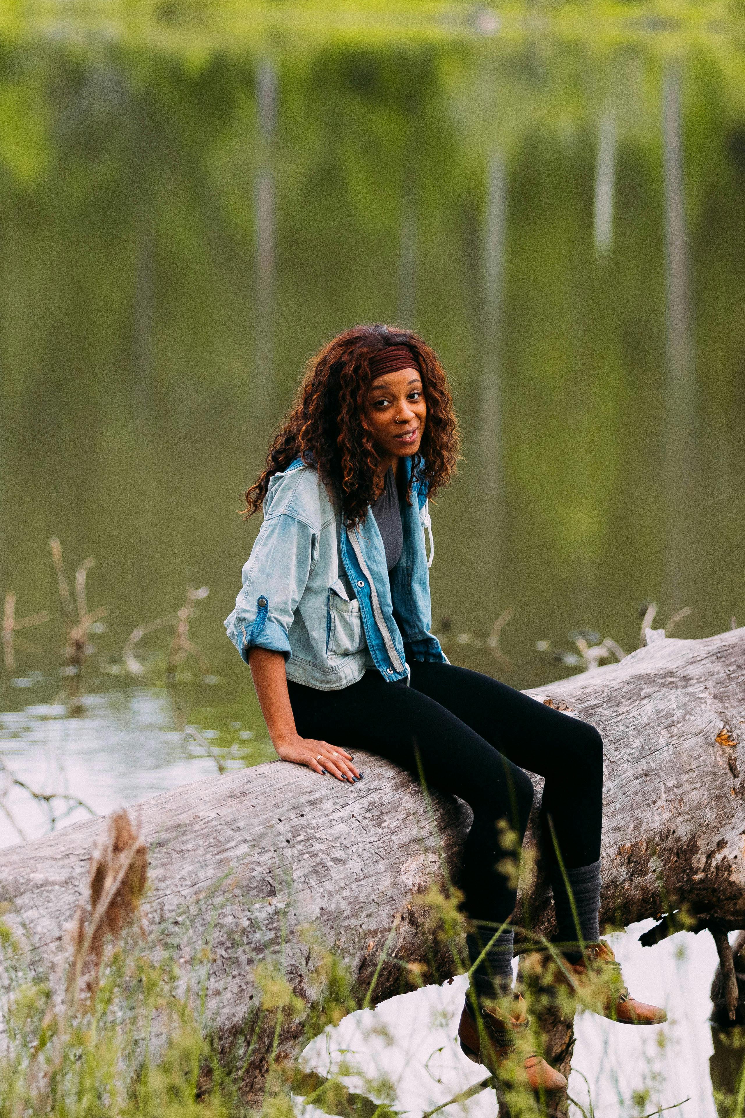 woman sitting on a tree trunk