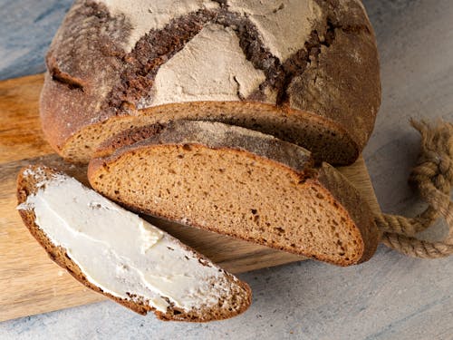 Darmowe zdjęcie z galerii z bochenek, chleb, deska do krojenia