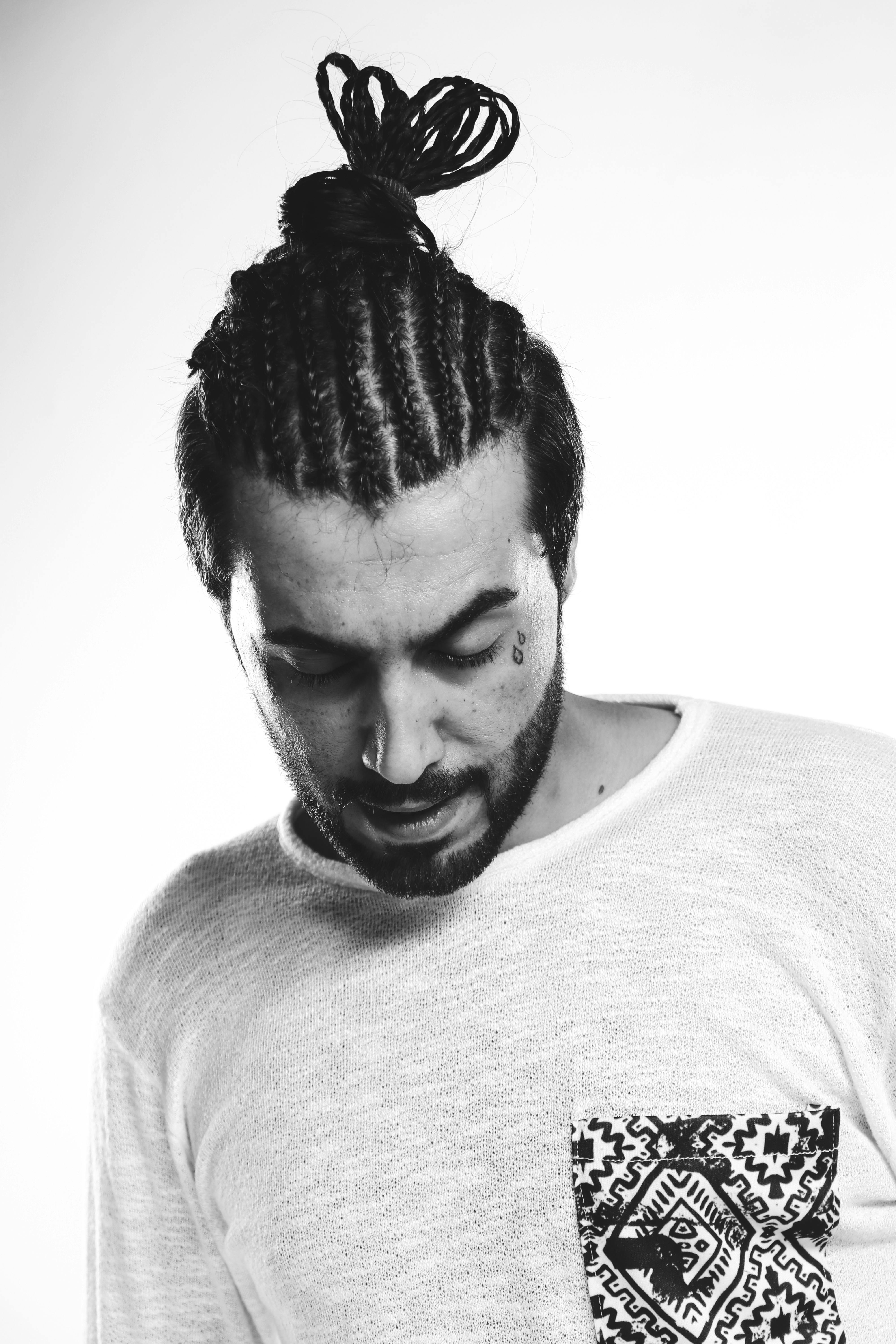 A Man with Braided Hair Wearing White Shirt · Free Stock Photo