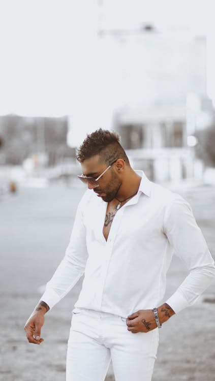 A Handsome Man in All White Outfit Looking Down Free Stock Photo