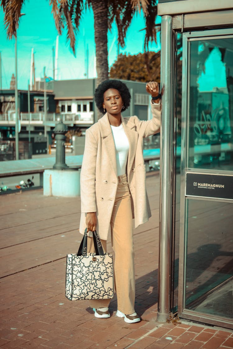 A Stylish Woman Leaning On A Pole