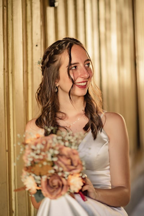 A Smiling Bride Holding a Bouquet