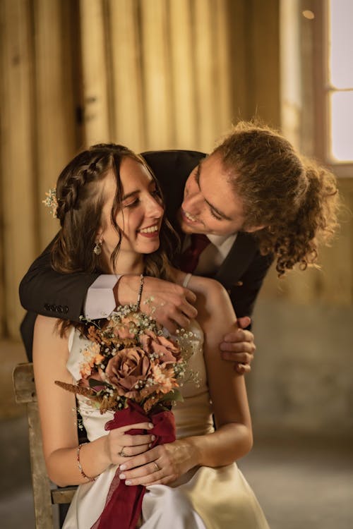 Bride and Groom Smiling while Looking at Each Other